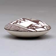 A miniature black on white seed pot decorated with a cloudeater, fish, fineline and geometric design above the shoulder, click or tap to see a larger version