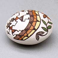 A miniature polychrome seed pot decorated with a pueblo dancer, rainbow, vine and geometric design above the shoulder, click or tap to see a larger version