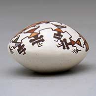 A miniature polychrome seed pot decorated with a pueblo dancer, rainbow, vine and geometric design above the shoulder, click or tap to see a larger version