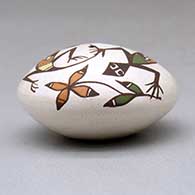 A miniature polychrome seed pot decorated with a lizard, plant and geometric design above the shoulder, click or tap to see a larger version