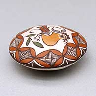 A miniature polychrome seed pot decorated with a parrot, branch and geometric design above the shoulder, click or tap to see a larger version