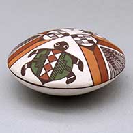 A polychrome seed pot decorated above the shoulder with a pueblo dancer, turtle, fineline and geometric design, click or tap to see a larger version