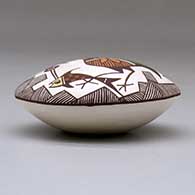 A polychrome seed pot decorated with a cloudeater, fish, fineline and geometric design above the shoulder, click or tap to see a larger version