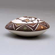 A polychrome seed pot decorated with a cloudeater, fish, fineline and geometric design above the shoulder, click or tap to see a larger version