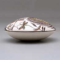 A polychrome seed pot decorated above the shoulder with a dragonfly, fish, fineline and geometric design, click or tap to see a larger version