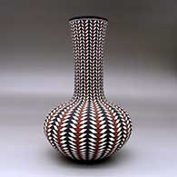 A tall neck polychrome vase decorated with a geometric design, click or tap to see a larger version