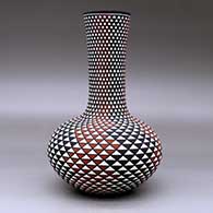 A tall neck polychrome vase decorated with a spiral mesa geometric design, click or tap to see a larger version