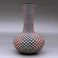 A tall neck polychrome vase decorated with a spiral mesa geometric design, click or tap to see a larger version