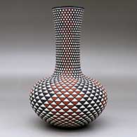 A tall neck polychrome vase decorated with a spiral mesa geometric design, click or tap to see a larger version