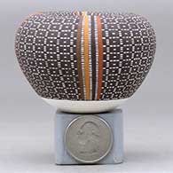 A miniature polychrome jar with an Infinity rim and decorated with a four-panel tiny-square geometric design, click or tap to see a larger version