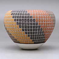A polychrome jar with an Infinity rim and decorated with a geometric design, click or tap to see a larger version