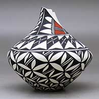 A polychrome tear drop jar with a kiva step cut opening and decorated with a pumpkin seed snowflake and geometric design, click or tap to see a larger version