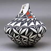 A polychrome tear drop jar with a kiva step cut opening and decorated with a pumpkin seed snowflake and geometric design, click or tap to see a larger version