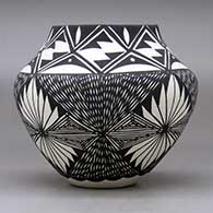 A black on white jar decorated with a four-panel fineline and geometric design, click or tap to see a larger version