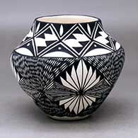 A black on white jar decorated with a four-panel fineline and geometric design
 by Sandra Victorino of Acoma