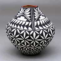 A polychrome jar with a square opening and decorated with a pumpkin seed snowflake and geometric design
 by Sandra Victorino of Acoma