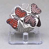 Click for a larger view A miniature polychrome seed pot decorated with butterfly wing appliques and a butterfly, fineline and geometric design
by Alisha Sanchez of Acoma