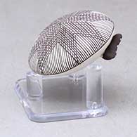 A miniature black on white seed pot decorated with a butterfly wing applique and a butterfly, fineline and geometric design, click or tap to see a larger version