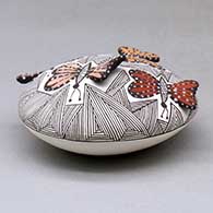 A polychrome seed pot decorated with butterfly wing appliques and a butterfly, fineline and geometric design, click or tap to see a larger version
