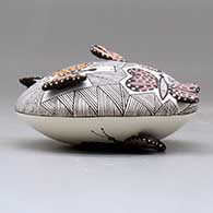 A polychrome seed pot decorated with butterfly wing appliques and a butterfly, fineline and geometric design, click or tap to see a larger version