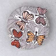A polychrome seed pot decorated with butterfly wing appliques and a butterfly, fineline and geometric design
 by Alisha Sanchez of Acoma