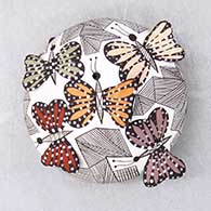 Click for a larger view A polychrome seed pot decorated with butterfly wing appliques and a butterfly, fineline and geometric design
by Alisha Sanchez of Acoma