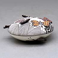 A polychrome seed pot decorated with butterfly wing appliques and a butterfly, fineline and geometric design, click or tap to see a larger version