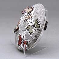 A polychrome seed pot decorated with butterfly wing appliques and a butterfly, fineline and geometric design, click or tap to see a larger version