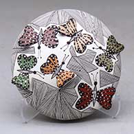 A polychrome seed pot decorated with butterfly wing appliques and a butterfly, fineline and geometric design
 by Alisha Sanchez of Acoma