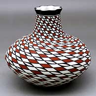 Click for a larger view A polychrome low-shouldered jar with a pie crust rim and decorated with a spiraling stylized checkerboard geometric design
by Paula Estevan of Acoma