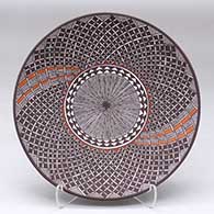 A polychrome plate decorated with a North Star fineline and geometric design
 by Amanda Lucario of Acoma