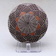 A small polychrome seed pot decorated with a North Star fineline and geometric design
 by Amanda Lucario of Acoma