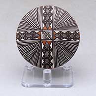 A miniature polychrome seed pot decorated with a fineline and geometric design above the shoulder
 by Amanda Lucario of Acoma