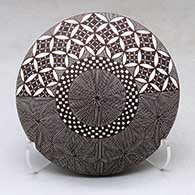 Click for a larger view A black on white seed pot decorated with a North Star fineline, yucca leaf snowflake, checkerboard and geometric design above the shoulder
by Rebecca Lucario of Acoma