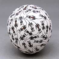 A polychrome seed pot decorated with a lizard design
 by Lilly M Salvador of Acoma