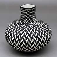 A black on white jar with a square neck and decorated with a basket weave geometric design
 by Paula Estevan of Acoma