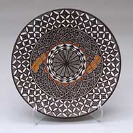 A polychrome plate decorated with a yucca-leaf snowflake, fineline and geometric design
 by Amanda Lucario of Acoma