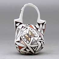 A small polychrome wedding vase decorated with a parrot, butterfly and geometric design, click or tap to see a larger version