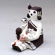 Click for a larger view A sitting grandmother storyteller figure with two children, a bird, kitten and lady bug
by Judy Lewis of Acoma