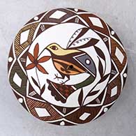 A polychrome seed pot decorated with a hummingbird, flower, fineline and geometric design
 by Diane Lewis of Acoma