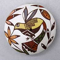 A miniature polychrome seed pot decorated with a hummingbird, flower and geometric design
 by Diane Lewis of Acoma
