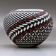 A polychrome jar decorated around the body with a painted checkerboard, yucca-leaf snowflake, feather and geometric design, click or tap to see a larger version