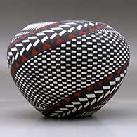 A polychrome jar decorated around the body with a painted checkerboard, yucca-leaf snowflake, feather and geometric design, click or tap to see a larger version