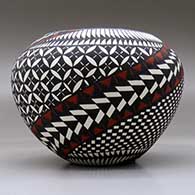 A polychrome jar decorated around the body with a painted checkerboard, yucca-leaf snowflake, feather and geometric design, click or tap to see a larger version