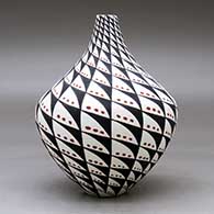 A polychrome tear drop jar decorated with a snowflake and spiral mesa geometric design, click or tap to see a larger version