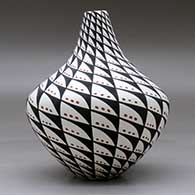 A polychrome tear drop jar decorated with a spiral mesa, snowflake and geometric design, click or tap to see a larger version
