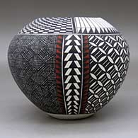 A polychrome jar decorated with a four-panel pumpkin seed snowflake, fineline, checkerboard, feather and geometric design, click or tap to see a larger version
