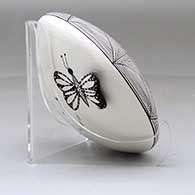 A black on white seed pot decorated with a butterfly wing applique and a butterfly, fineline and geometric design, click or tap to see a larger version