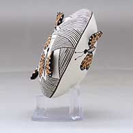 A polychrome seed pot decorated with butterfly wing appliques and a butterfly, fineline and geometric design, click or tap to see a larger version