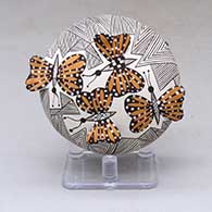 A polychrome seed pot decorated with butterfly wing appliques and a butterfly, fineline and geometric design
 by Alisha Sanchez of Acoma
